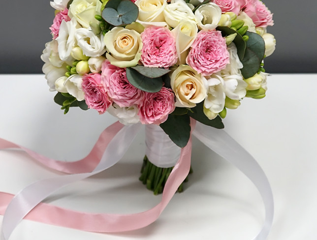 Bride's bouquet of pink spray roses, white roses, freesias and eucalyptus photo